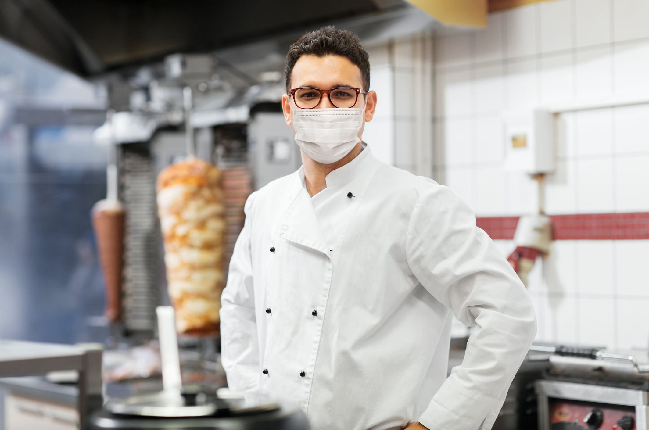 Chef in commercial kitchen wearing a mask